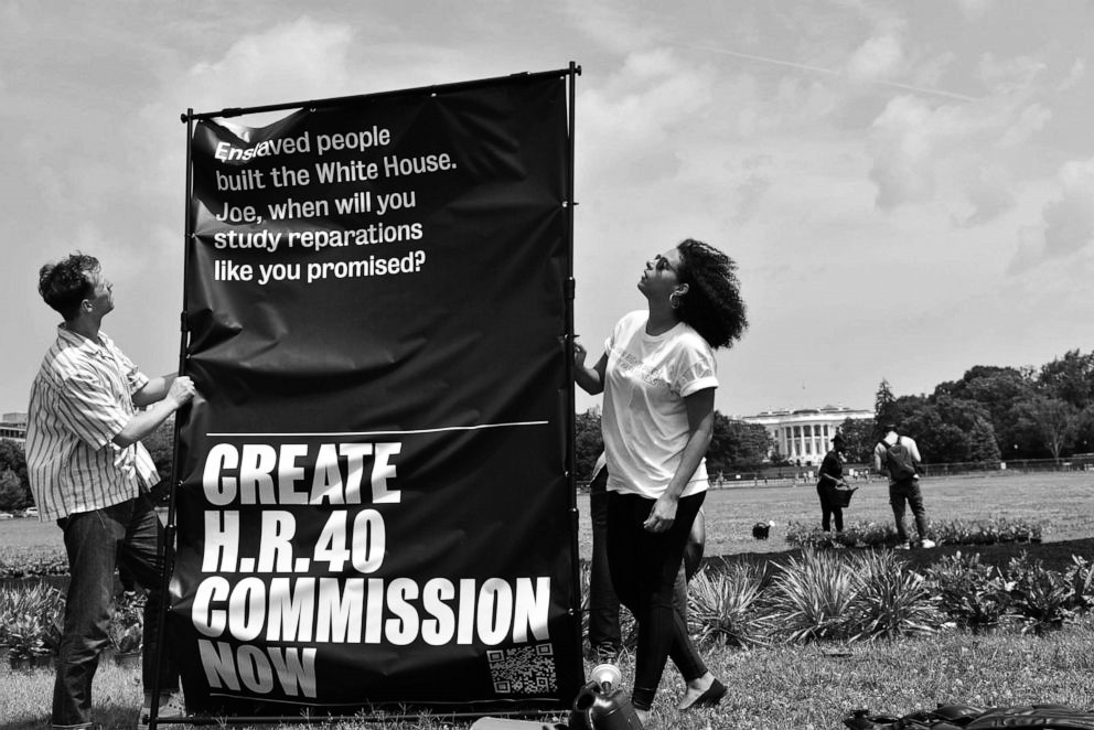 Activists at the White House with a banner reading "Create H.R.40 Commission Now"