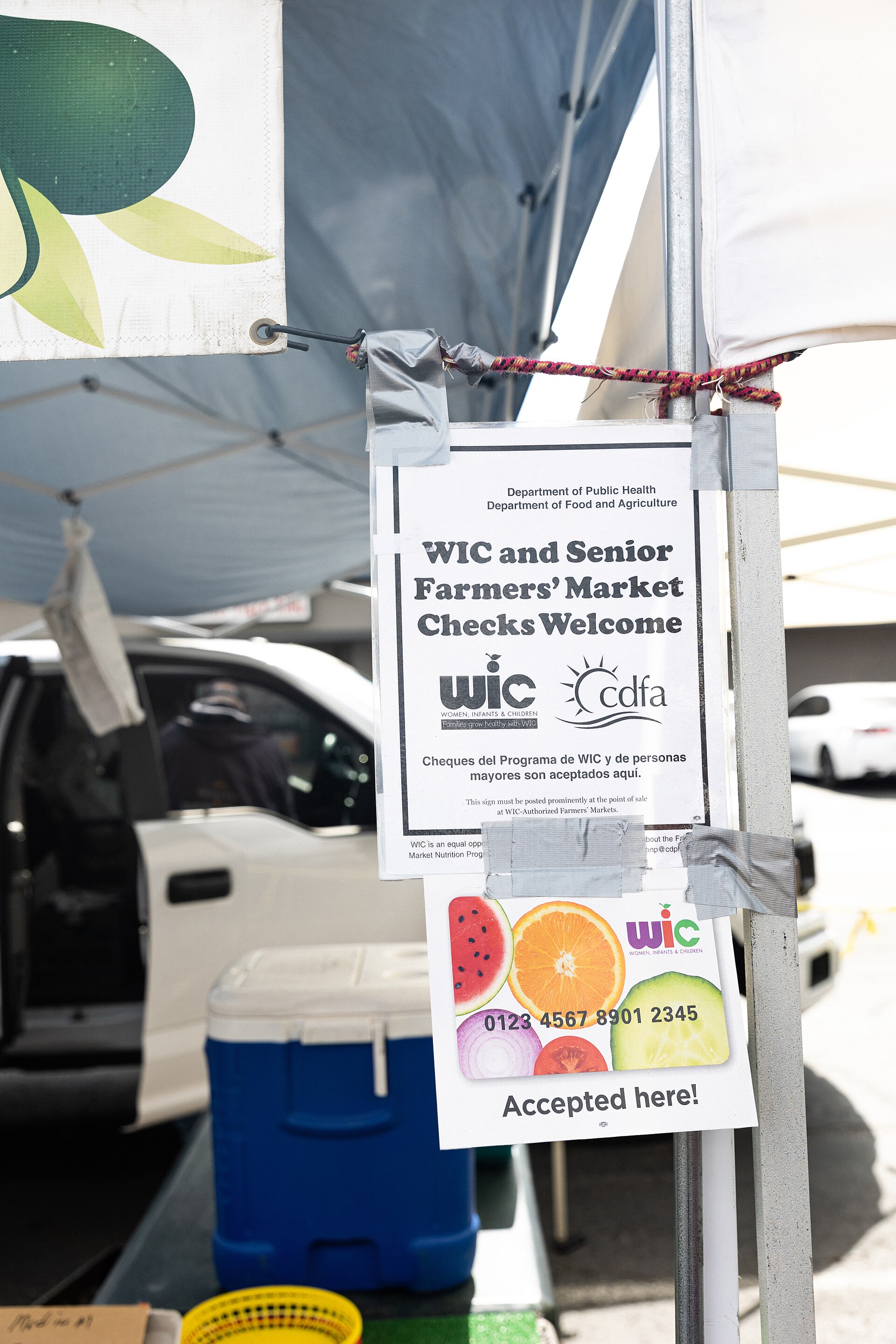 A family at a WIC / farmers-market nutrition program with fresh produce